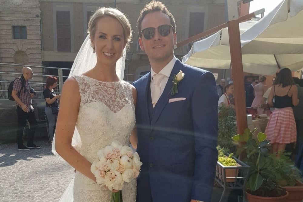 Emma and Red pose for a photo on their wedding day in Italy