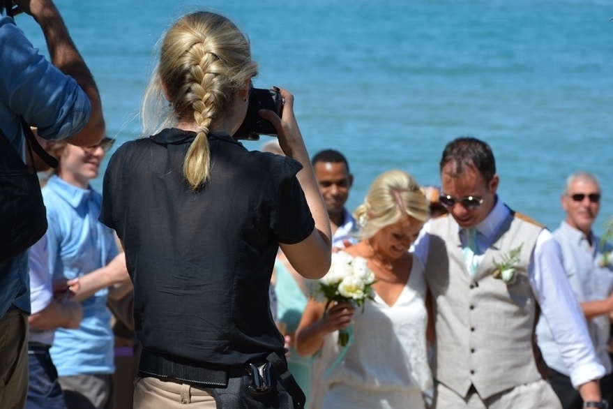 an example of an Italian female photographer and a couple having a destination beach wedding