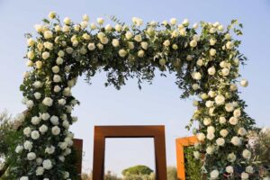 wedding arch decorated with white roses