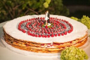 traditional Italian Mille Foglie wedding cake with red berries.