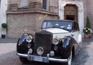 two tone classic Rolls Royce wedding car parked outside a wedding venue in Rome