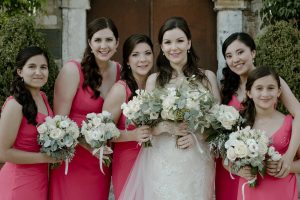 Bride and bridesmaids holding Ivory and olive bridal bouquets created for a vineyard wedding at Castello di Semivicoli Abruzzo. Italy.