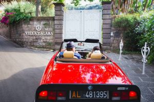 couple arriving at Villa Zagara - wedding venue in Sorrento in a sports car