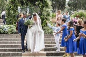 Bride and groom walking down an aisle in an Italian garden at wedding venue in Sorrento