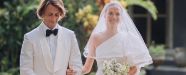 well dressed couple walk down the aisle at a stylish Italian wedding