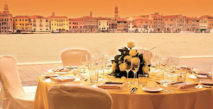 wedding dining table with flowers and view of grand canal Venice behind