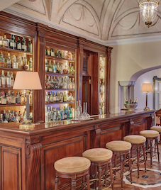 classic wooden bar with drinks cabinet and 5 bar stools