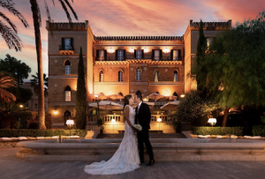bride and groom standing in front of villa ivies in Sicily after their wedding