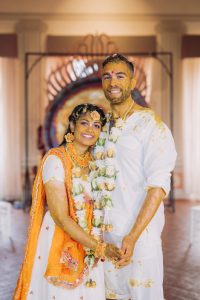 Bride & groom covered in turmeric during haldi at Indian wedding in Italy