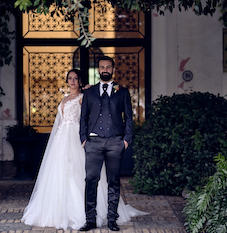 Bride and groom stand at entrance to Masseria Casamarte in Abruzzo.