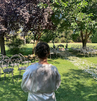 Bride surveys wedding ceremony set up in a beautiful Italian garden on the morning of her wedding.