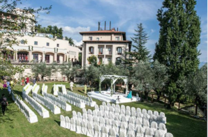 Large Indian wedding ceremony set up on a lawn at a hotel in Tuscany, Italy