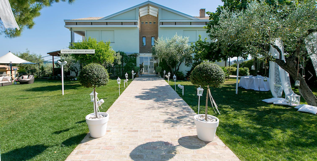 Wedding villa in Abruzzo, Italy with sun on the garden path leading through the lawned garden to the front door.