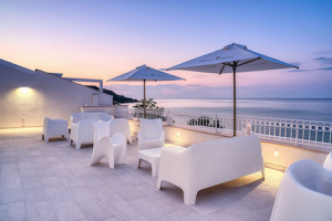 Luxury roof terrace overlooking the Adriatic Sea. Set up with comfortable seating and sun umbrellas. Perfect Amalfi Coast style wedding venue.