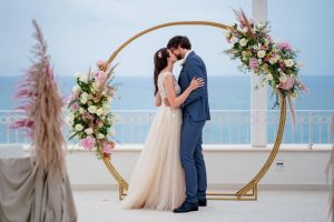 wedding couple marriage ceremony on a terrace overlooking the sea in italy