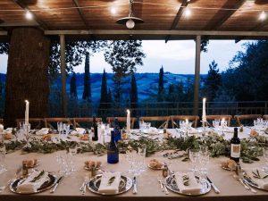 wedding dining table set in Tuscany with rural view behind.