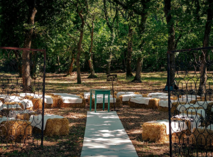 A rustic wedding ceremony set up in. an ancient Italian woodland.